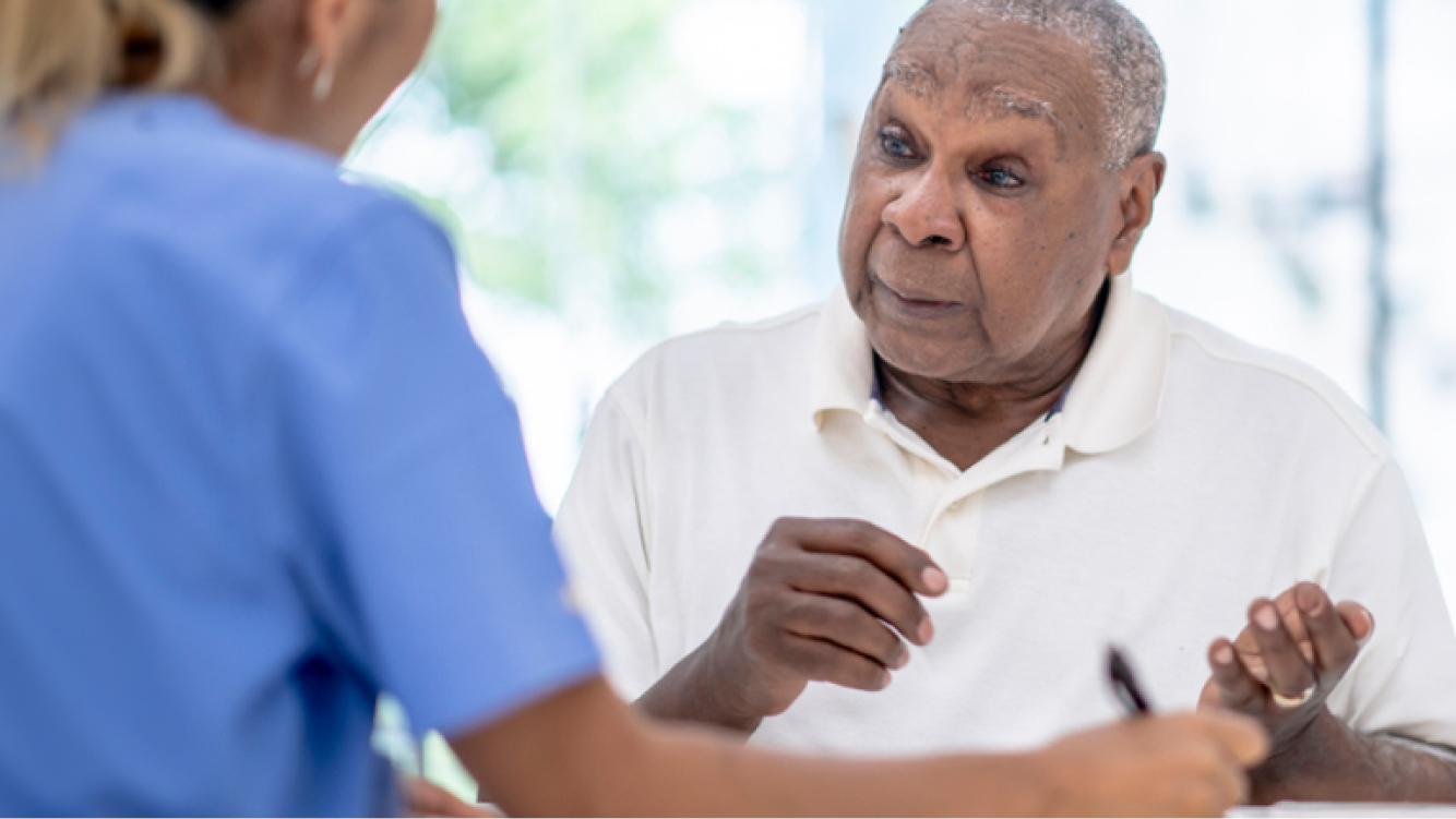 A man speaking to a healthcare professional
