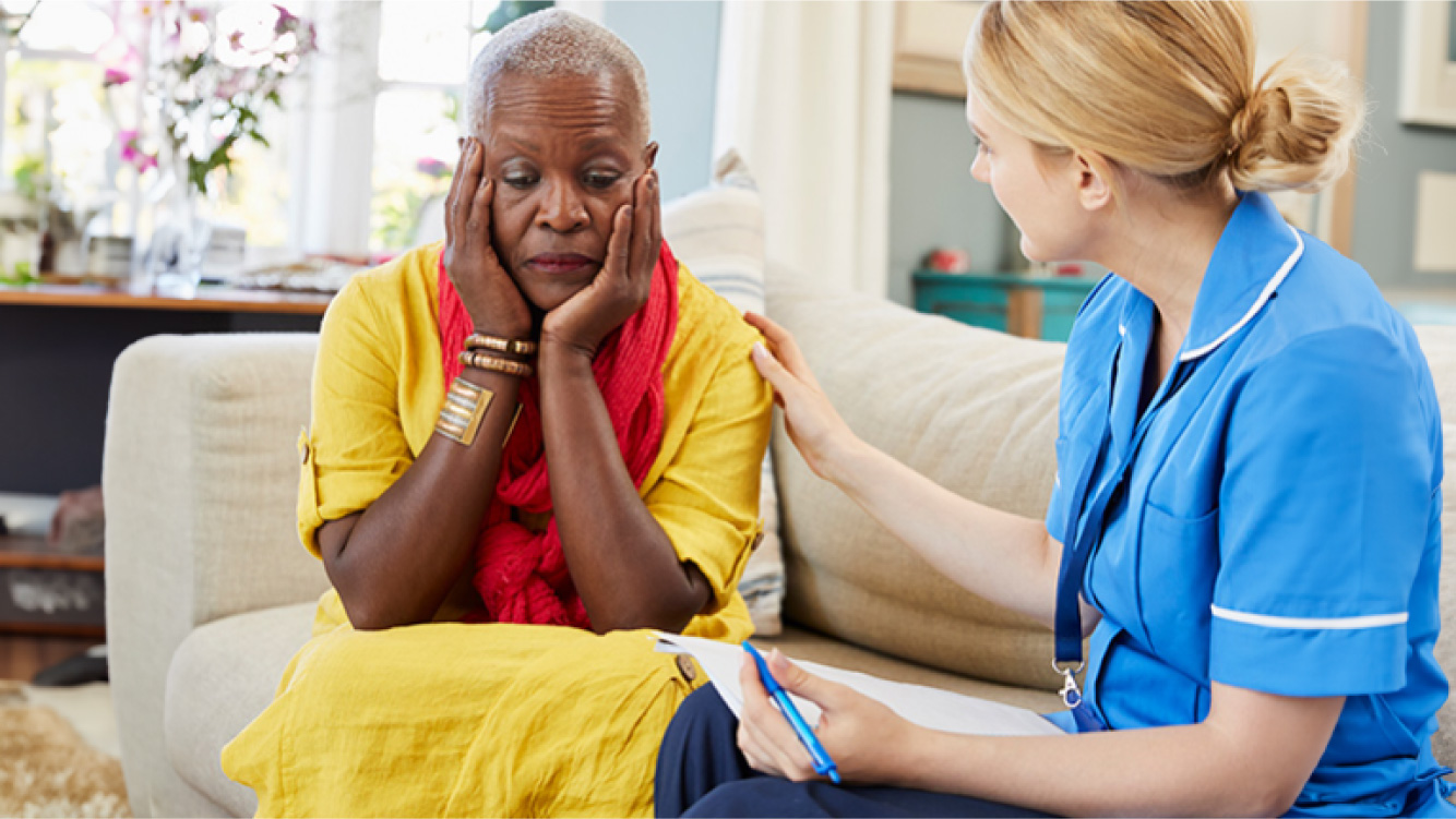 A woman being comforted by a healthcare professional