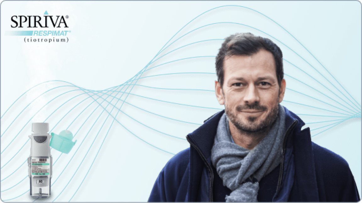 SPIRIVA (tiotropium) Respimat inhaler device with cap removed while releasing solution into the air plus logo and male patient