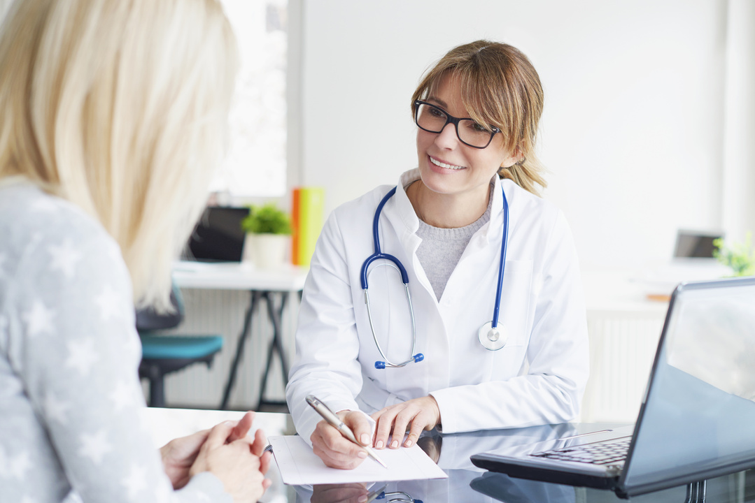 Female healthcare professional consulting with her patient
