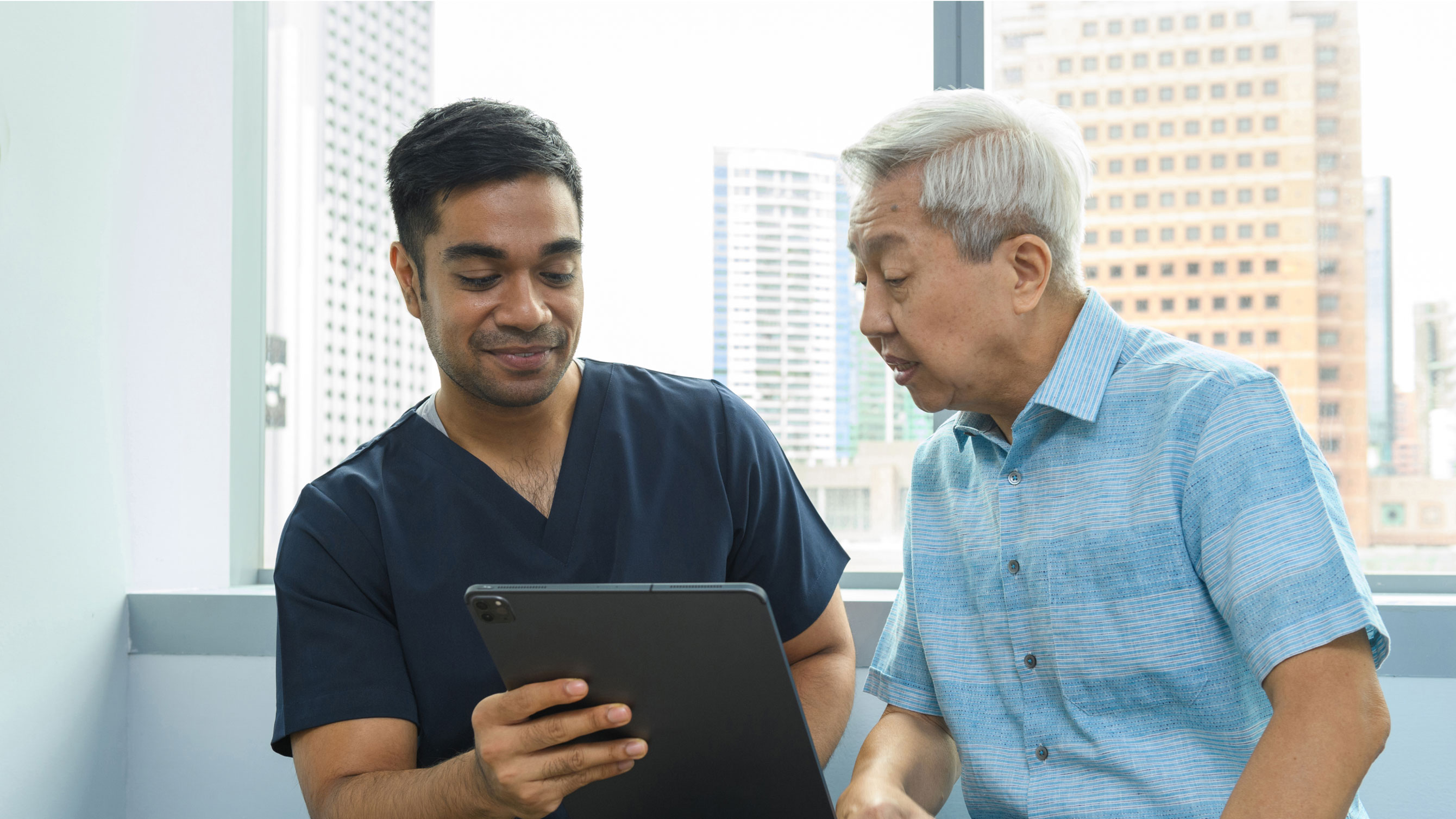 Elderly person talking to a healthcare professional