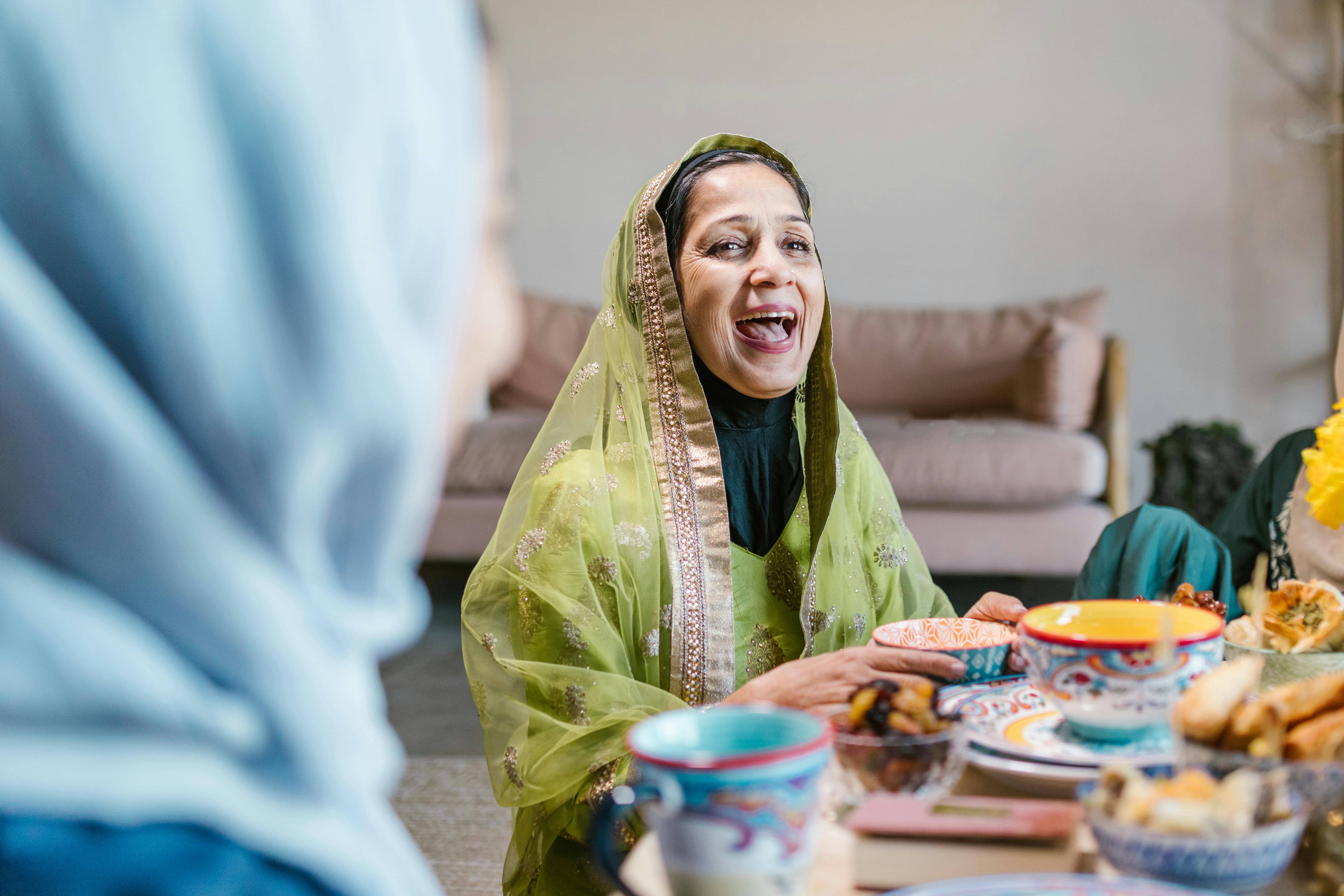 Smiling Muslim Woman Enjoying Iftar During Ramadan