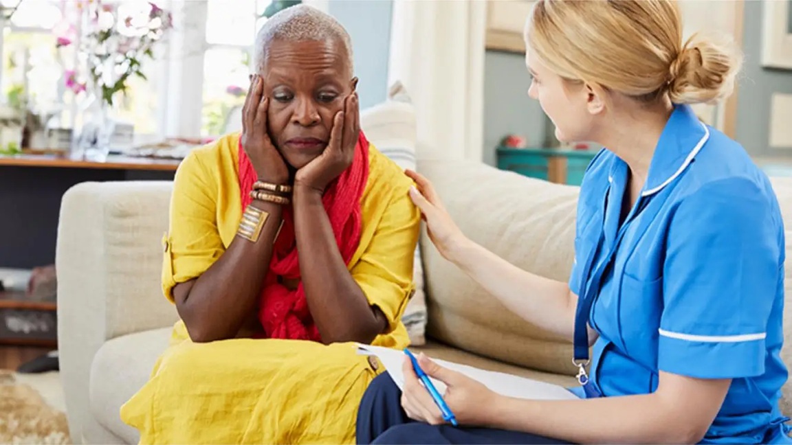 A woman being comforted by a healthcare professional