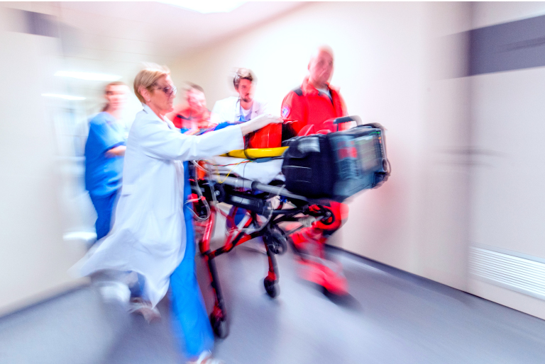 hcps-wheeling-patient-through-hospital